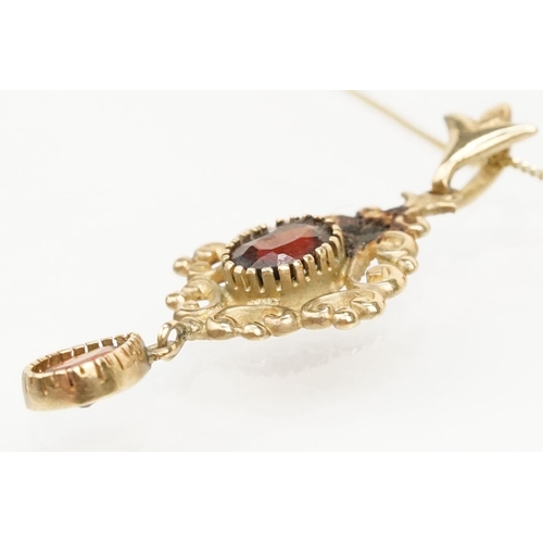 101 - Suite of 9ct gold and garnet jewellery to include a pendant necklace with fine link chain and scroll... 