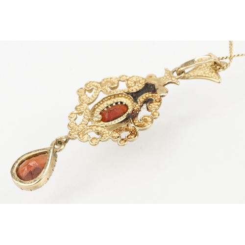 101 - Suite of 9ct gold and garnet jewellery to include a pendant necklace with fine link chain and scroll... 