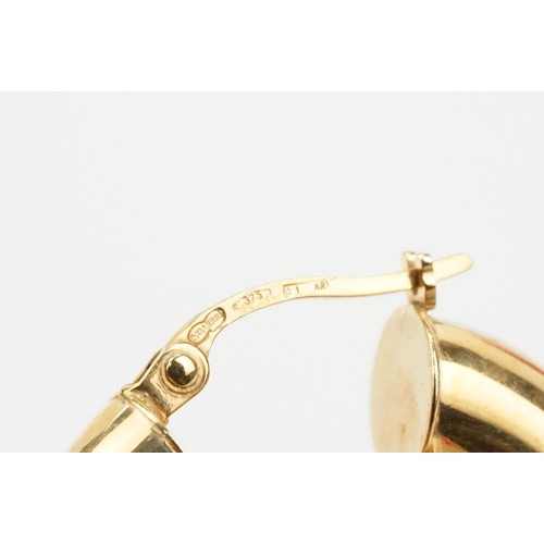 107 - Two pairs of 9ct gold hoop earrings to include a pair of oval hoops with hinged posts (marked 375) a... 