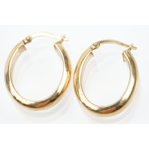 107 - Two pairs of 9ct gold hoop earrings to include a pair of oval hoops with hinged posts (marked 375) a... 