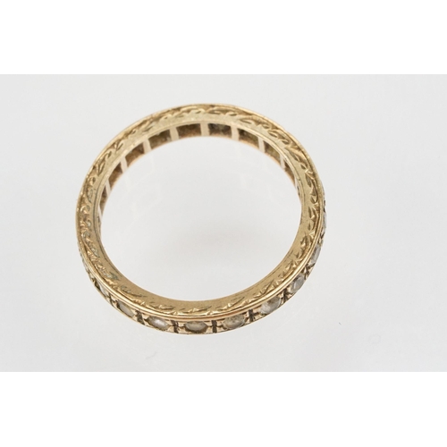 110 - 9ct gold and white stone eternity ring with incised details (marked 9ct, size K) together with a 9ct... 