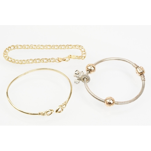 115 - Group of three bracelets to include a 9ct gold open bangle with heart shaped terminals (hallmarked S... 