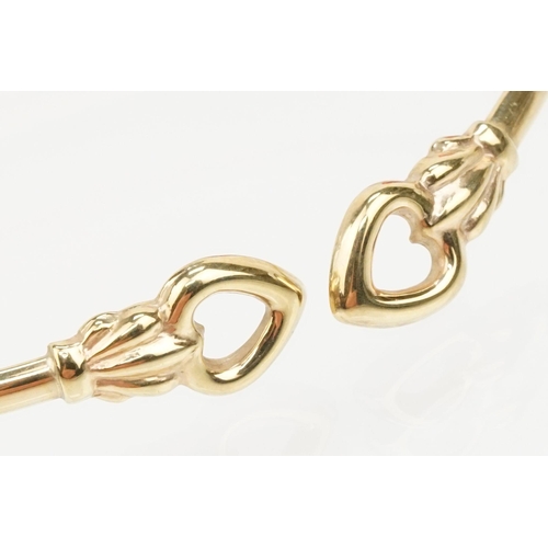 115 - Group of three bracelets to include a 9ct gold open bangle with heart shaped terminals (hallmarked S... 