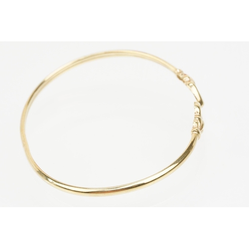 115 - Group of three bracelets to include a 9ct gold open bangle with heart shaped terminals (hallmarked S... 