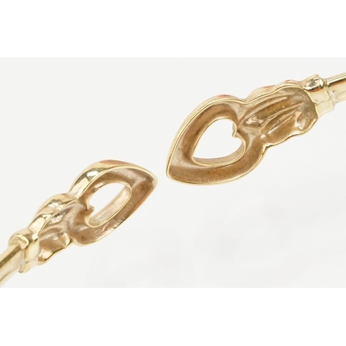 115 - Group of three bracelets to include a 9ct gold open bangle with heart shaped terminals (hallmarked S... 