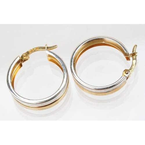 118 - Pair of 9ct gold two tone hoop earrings with hinged posts. Marked 375 to the posts. Measures 1.8cm d... 