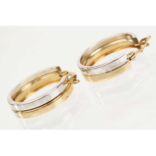 118 - Pair of 9ct gold two tone hoop earrings with hinged posts. Marked 375 to the posts. Measures 1.8cm d... 