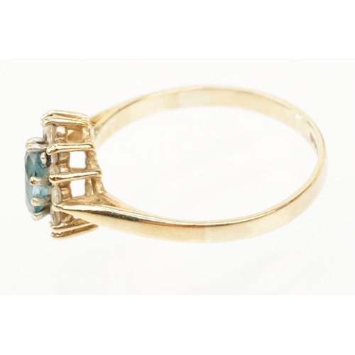 121 - Two hallmarked 9ct gold rings to include a blue topaz and cz cluster ring (hallmarked to shank), and... 