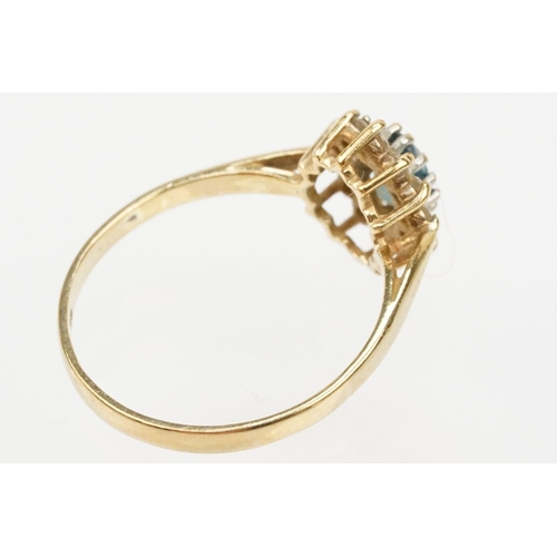 121 - Two hallmarked 9ct gold rings to include a blue topaz and cz cluster ring (hallmarked to shank), and... 