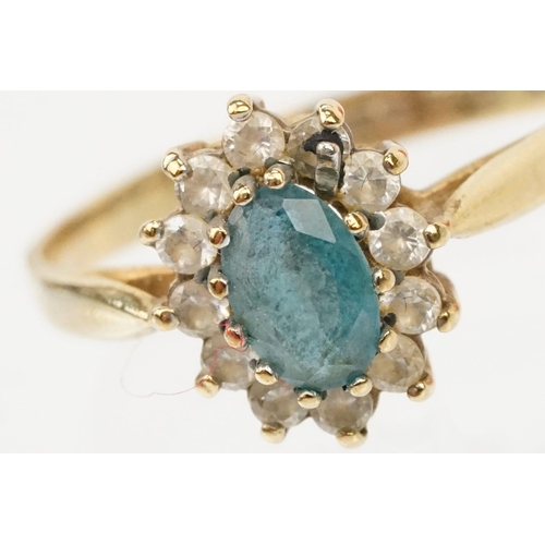 121 - Two hallmarked 9ct gold rings to include a blue topaz and cz cluster ring (hallmarked to shank), and... 