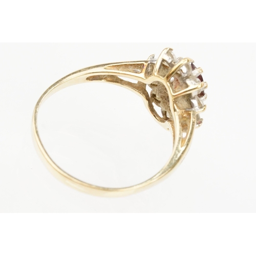 121 - Two hallmarked 9ct gold rings to include a blue topaz and cz cluster ring (hallmarked to shank), and... 