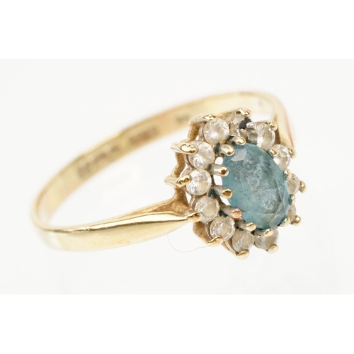 121 - Two hallmarked 9ct gold rings to include a blue topaz and cz cluster ring (hallmarked to shank), and... 