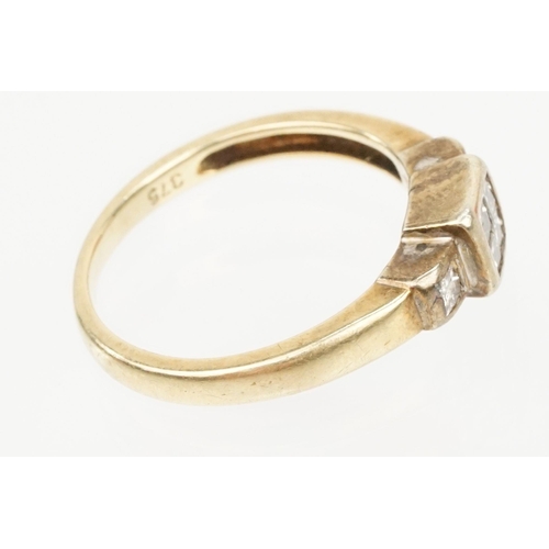 126 - 9ct gold and diamond ring. The ring being set with four princess cut diamonds to the head and two fu... 