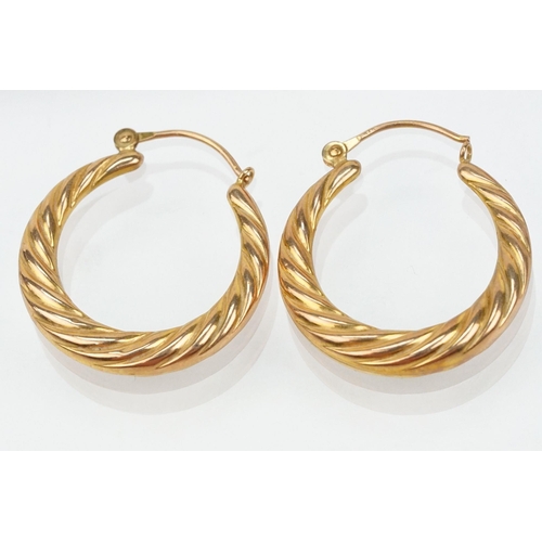 133 - Three pairs of hoop earrings to include a pair of 9ct  two tone cross over earrings (marked 375 to p... 