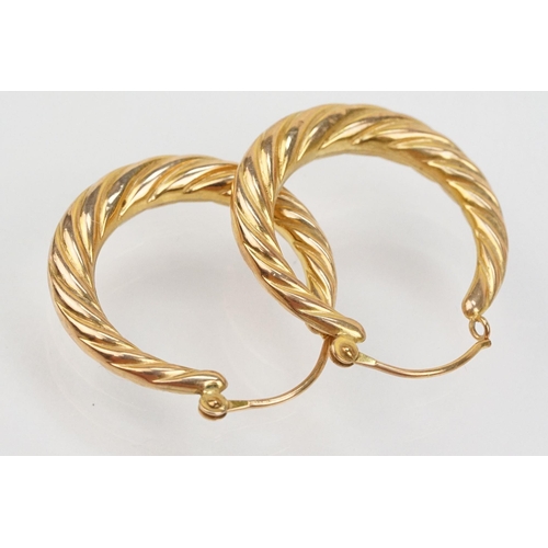 133 - Three pairs of hoop earrings to include a pair of 9ct  two tone cross over earrings (marked 375 to p... 