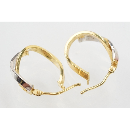 133 - Three pairs of hoop earrings to include a pair of 9ct  two tone cross over earrings (marked 375 to p... 