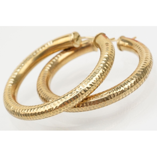 135 - Pair of 9ct gold hollow hoop earrings with hinged posts. Hallmarked 375 to posts. Measures 4cm diame... 