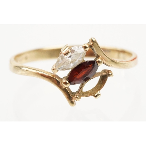 151 - 9ct gold ring set with a marquise cut garnet to centre and marquise cut white stone (one missing, si... 