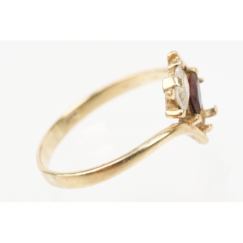 151 - 9ct gold ring set with a marquise cut garnet to centre and marquise cut white stone (one missing, si... 