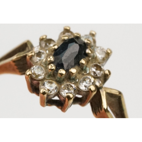 179 - 9ct gold sapphire and cz cluster ring having a marquise cut sapphire to centre surrounded by CZ's wi... 