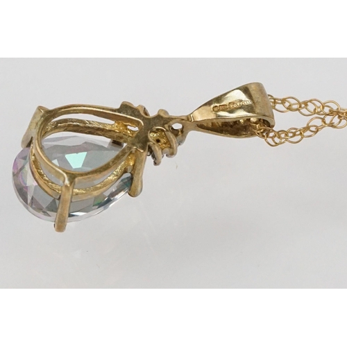 181 - Two 9ct gold pendant necklaces to include a mystic topaz set pendant on a fine link chain and a lyre... 