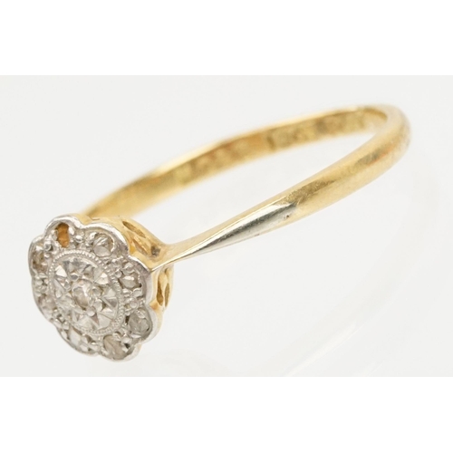 199 - 18ct gold and platinum daisy ring. The ring set with diamond accent stones to the head. Marked 18ct ... 