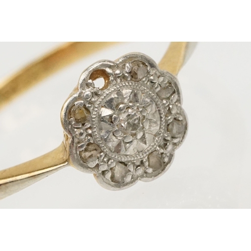 199 - 18ct gold and platinum daisy ring. The ring set with diamond accent stones to the head. Marked 18ct ... 