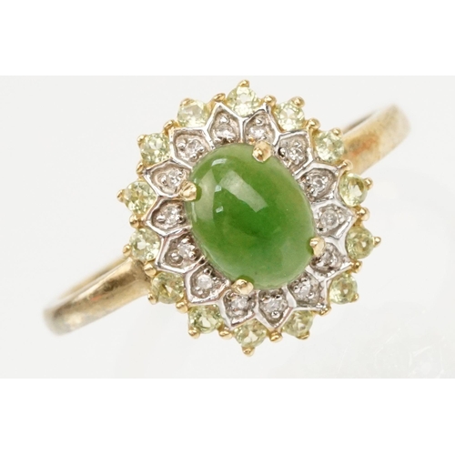 200 - 9ct gold jade and diamond cluster ring. The ring being set with an oval jade cabochon to centre with... 