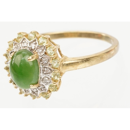 200 - 9ct gold jade and diamond cluster ring. The ring being set with an oval jade cabochon to centre with... 