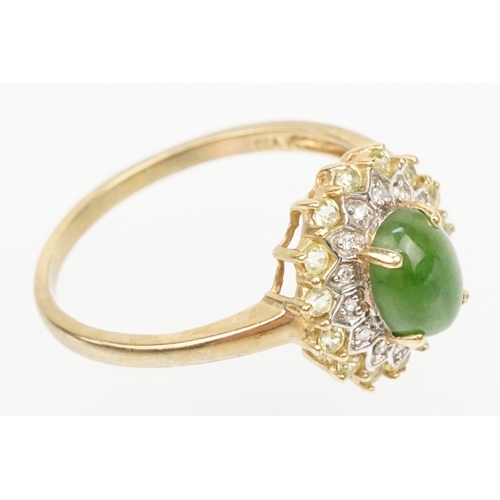 200 - 9ct gold jade and diamond cluster ring. The ring being set with an oval jade cabochon to centre with... 