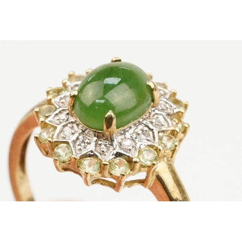 200 - 9ct gold jade and diamond cluster ring. The ring being set with an oval jade cabochon to centre with... 