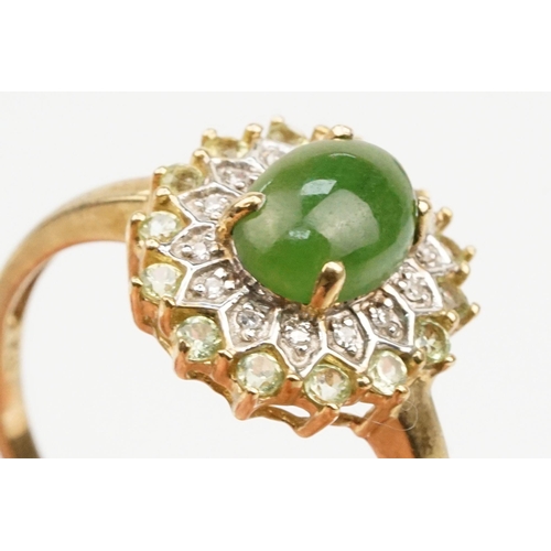 200 - 9ct gold jade and diamond cluster ring. The ring being set with an oval jade cabochon to centre with... 