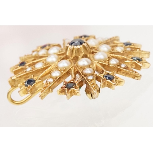 32 - 14ct gold, sapphire and pearl star brooch set with nine round cut sapphires and graduating half pear... 