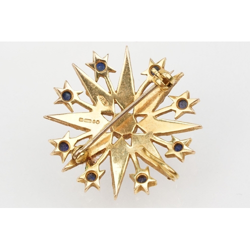 32 - 14ct gold, sapphire and pearl star brooch set with nine round cut sapphires and graduating half pear... 