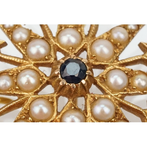 32 - 14ct gold, sapphire and pearl star brooch set with nine round cut sapphires and graduating half pear... 