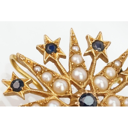 32 - 14ct gold, sapphire and pearl star brooch set with nine round cut sapphires and graduating half pear... 