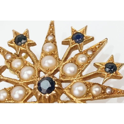 32 - 14ct gold, sapphire and pearl star brooch set with nine round cut sapphires and graduating half pear... 