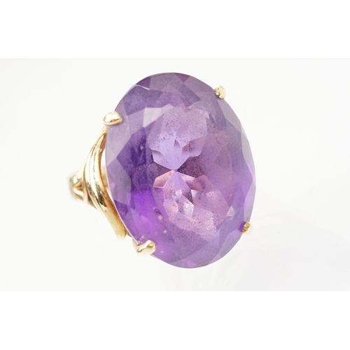 35 - 14ct gold and amethyst dress ring. The ring being set with a large oval cut amethyst in a basket hea... 