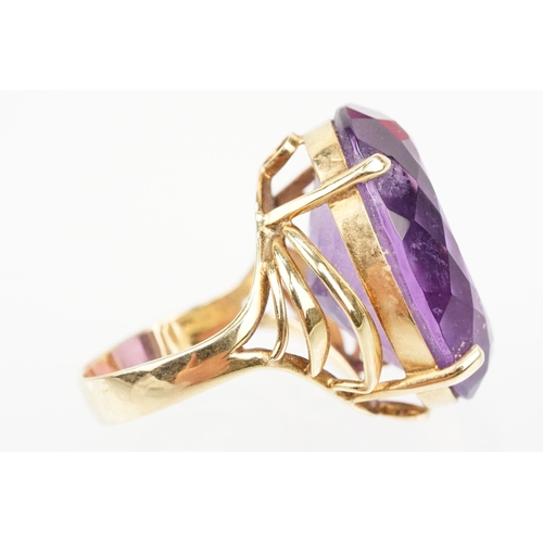 35 - 14ct gold and amethyst dress ring. The ring being set with a large oval cut amethyst in a basket hea... 