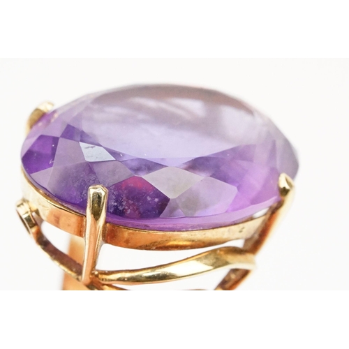 35 - 14ct gold and amethyst dress ring. The ring being set with a large oval cut amethyst in a basket hea... 