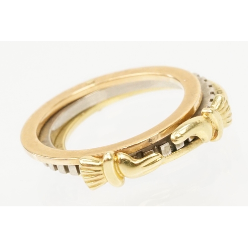 36 - 18ct gold tri tone ring constructed from three interlocking rings with clasped hands to the head, op... 