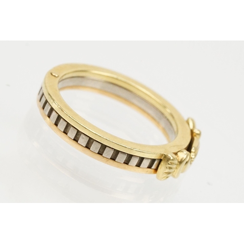 36 - 18ct gold tri tone ring constructed from three interlocking rings with clasped hands to the head, op... 