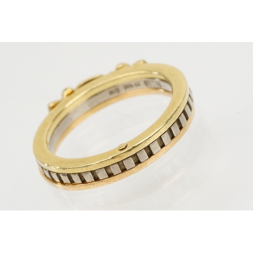 36 - 18ct gold tri tone ring constructed from three interlocking rings with clasped hands to the head, op... 