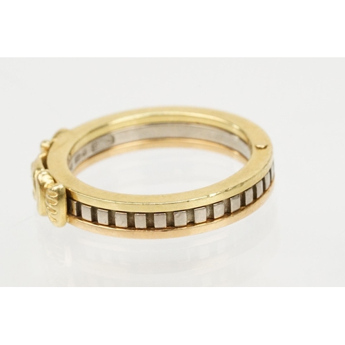 36 - 18ct gold tri tone ring constructed from three interlocking rings with clasped hands to the head, op... 