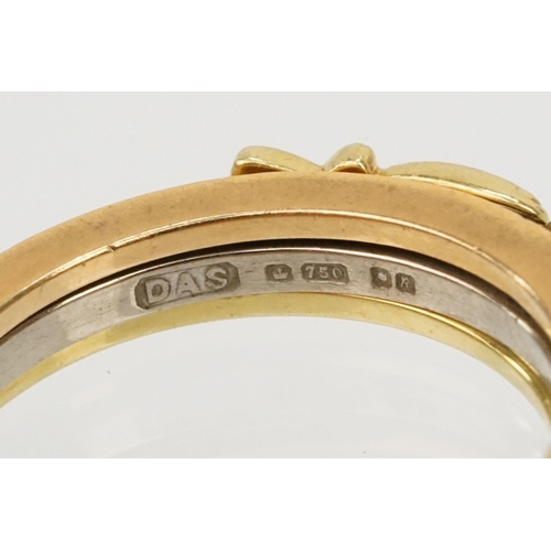 36 - 18ct gold tri tone ring constructed from three interlocking rings with clasped hands to the head, op... 