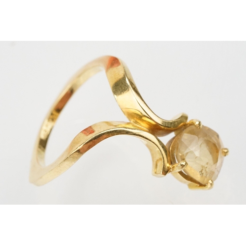 38 - 18ct gold and citrine ring. The ring being set with a cushion cut citrine on scrolled shoulders. Mar... 