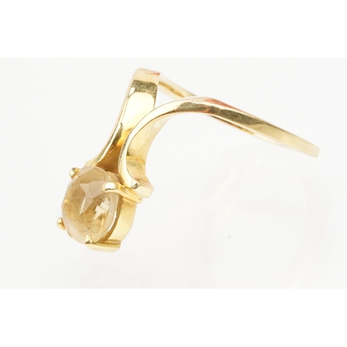 38 - 18ct gold and citrine ring. The ring being set with a cushion cut citrine on scrolled shoulders. Mar... 