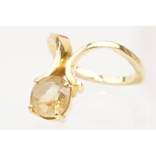 38 - 18ct gold and citrine ring. The ring being set with a cushion cut citrine on scrolled shoulders. Mar... 