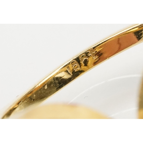 38 - 18ct gold and citrine ring. The ring being set with a cushion cut citrine on scrolled shoulders. Mar... 