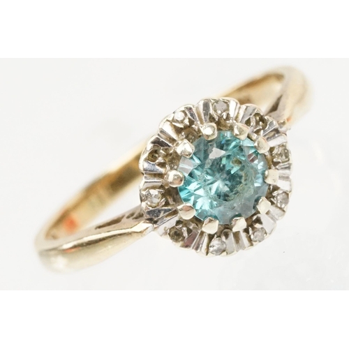 50 - 9ct gold zircon and diamond halo ring. The ring being set with a round cut zircon to the centre surr... 